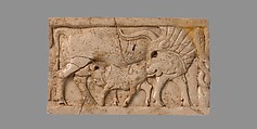 Furniture plaque carved in relief with a cow suckling a calf, Ivory, Assyrian